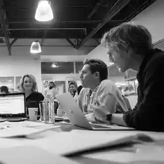 Team workshop around a table in black and white