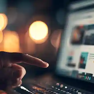 Creative workstation with a designer pointing at a screen