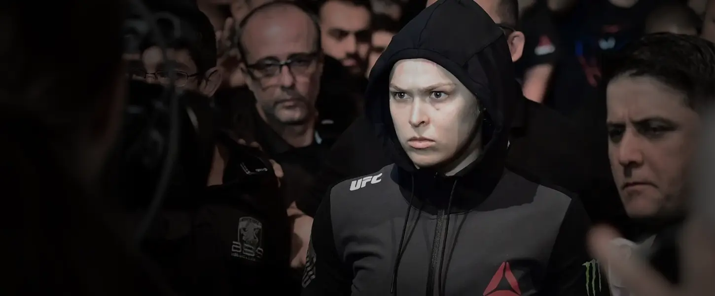 UFC fighter walking through a crowd in black Reebok apparel