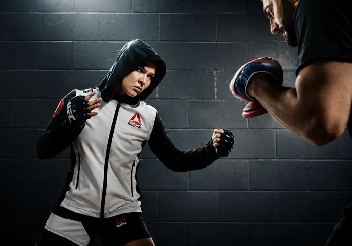 Fighter in a UFC Reebok vest training in a gym