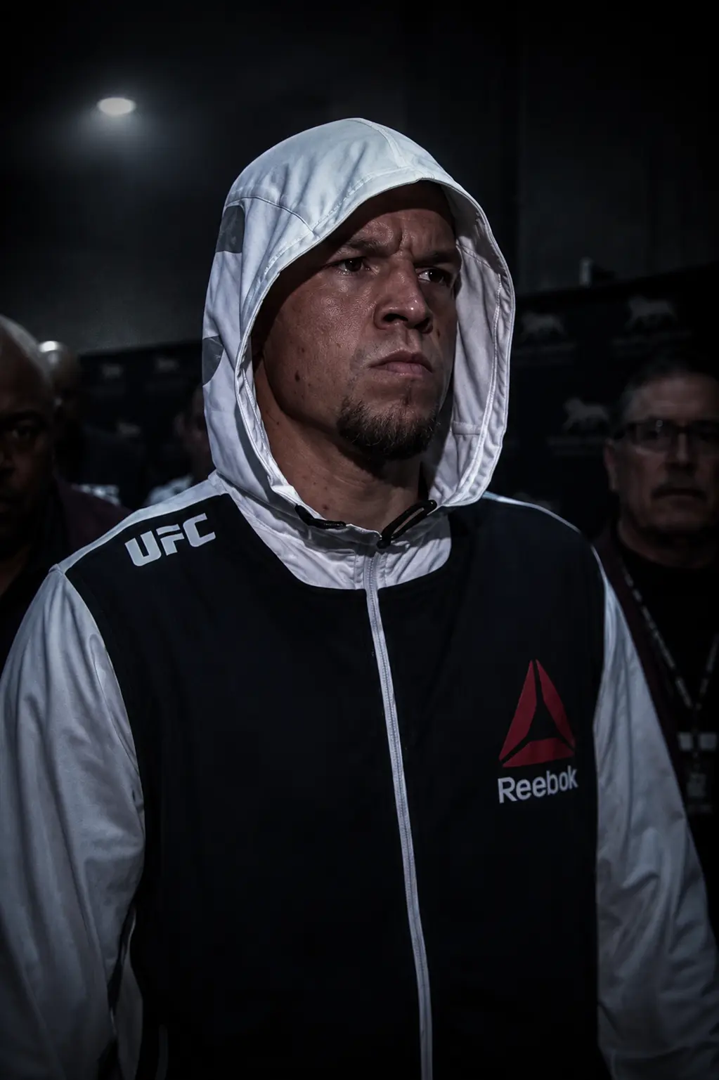 Fighter in a white Reebok hoodie before a UFC event
